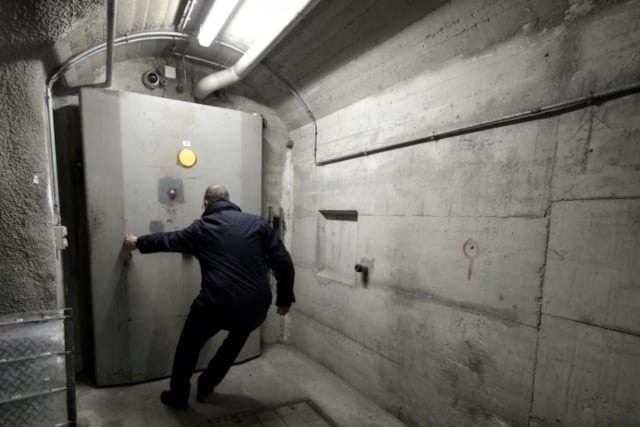 A man opens the door of a bunker, where there might be chocolate inside. 
