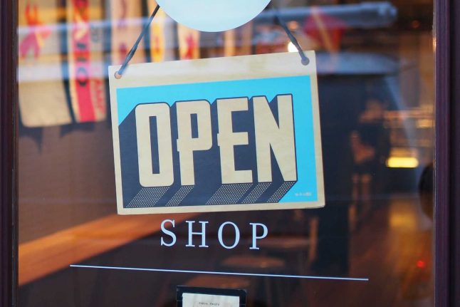 An 'open' sign in a shop window.