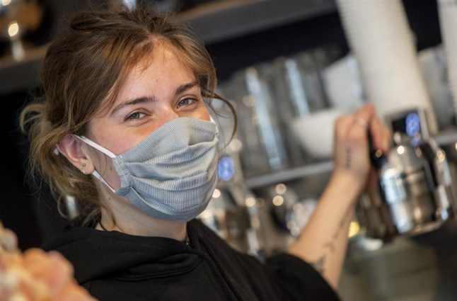 'It's warm and you can't breathe well': Germans don face masks to slow coronavirus spread