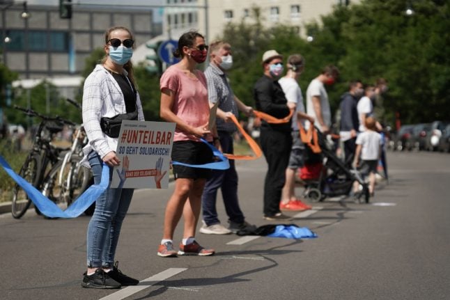 Thousands of Berliners form socially-distanced human chain against racism