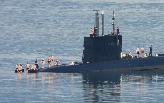 Norwegian submarine crew strips down to trunks and bikinis