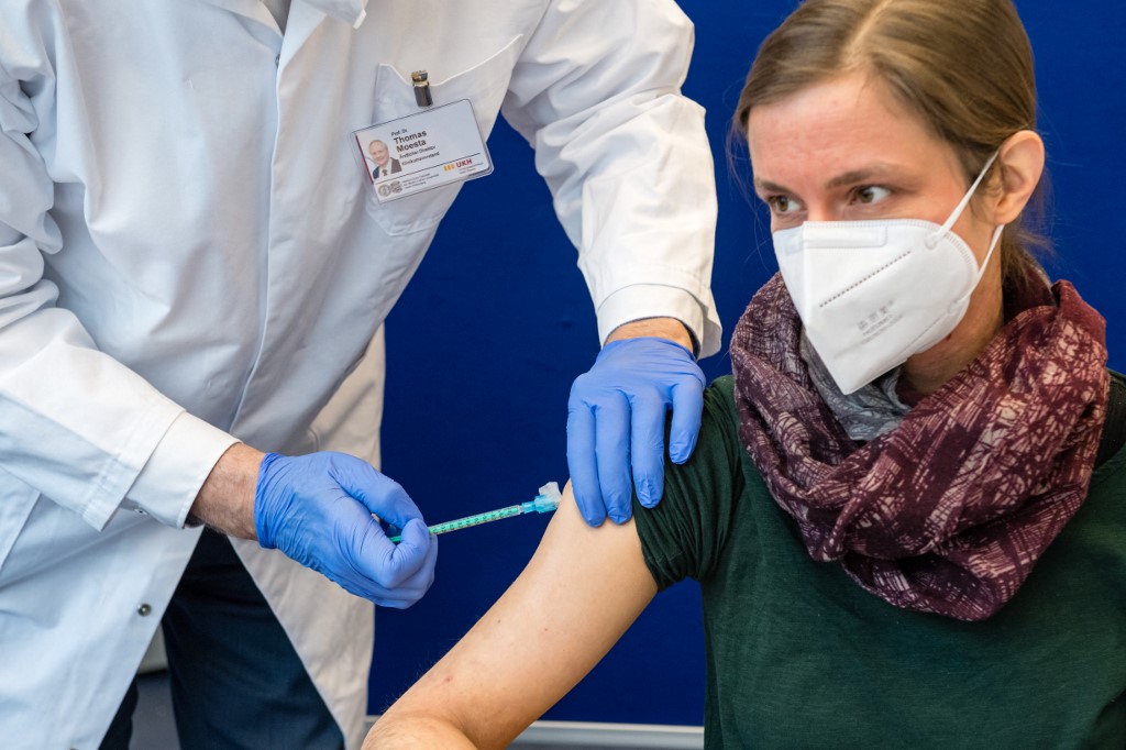 A healthcare worker receives the AstraZeneca vaccine JENS SCHLUETER / AFP