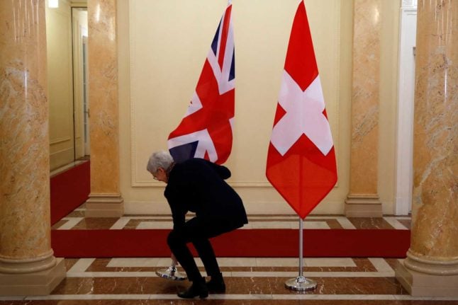 A Union Jack - the flag of  the United Kingdom - next to a Swiss flag in Switzerland. Photo: STEFAN WERMUTH / AFP