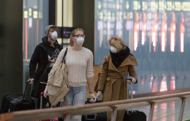 Landed passengers with face masks at Vienna Airport in Schwechat