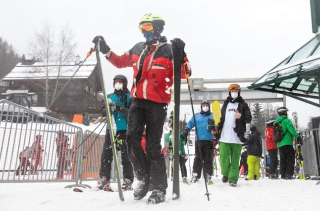 Skiers use a ski lift in Austria (Photo by ALEX HALADA / AFP)