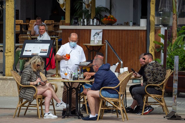 Tourists drink at a bar in Mallorca