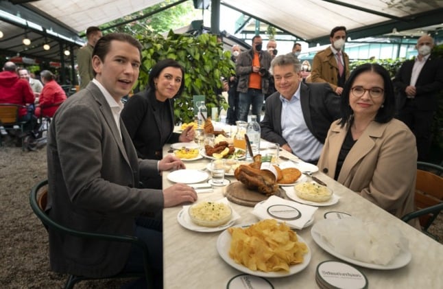    Austrian Chancellor Sebastian Kurz, Tourism Minister Elisabeth Koestinger, Vice-Chancellor Werner Kogler and the secretary for culture Andrea Mayer have lunch at the Schweizerhouse in the Prater  in Vienna. (Photo by JOE KLAMAR / AFP)