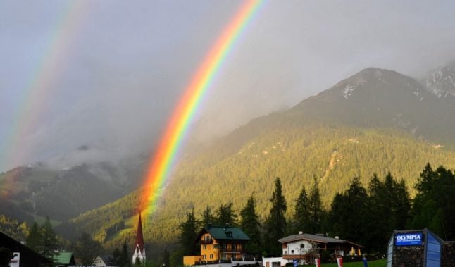 A rainbow is seen over Tyrolian village of Seefeld in Austria (Photo by SAMUEL KUBANI / AFP)