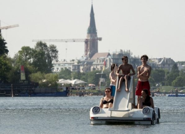 People make their way in pedal boats on the Old Danube (Alte Donnau), a subsidiary of the Danube river, in Vienna, Austria  (Photo by JOE KLAMAR / AFP)