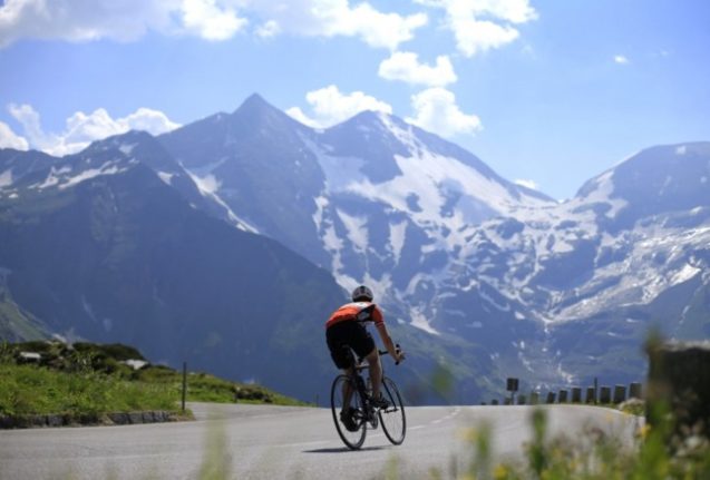 A cyclist rides on the Grossglockner high alpine road, in the mountains of the Hohe Tauern, near Zell am See. (Photo by ALEXANDER KLEIN / AFP)