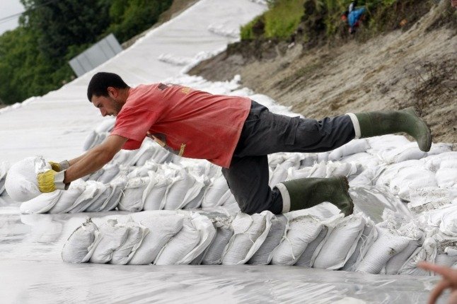 People in Austria have been putting up sand bags to protect their homes. (Photo by FERENC ISZA / AFP)