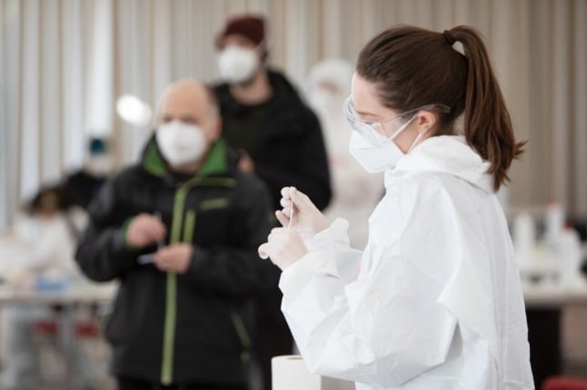 A health worker prepares a coronavirus antigen rapid test (Photo by ALEX HALADA / AFP)