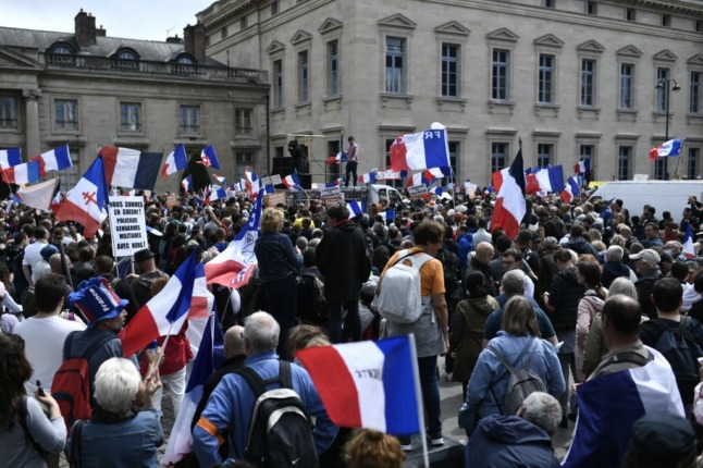 UPDATE: Protesters mass in France against Macron's Covid health pass
