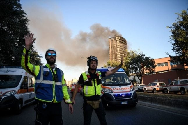 Firefighters are seen at the site where a 20 storey residential building is ravaged by a fire in Milan. Piero CRUCIATTI / AFP