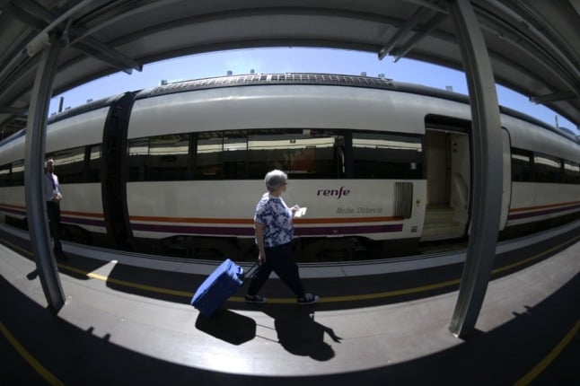 A passenger about to board a Renfe train in Madrid. Spain's public rail workers announced a strike for late September and early October 2021