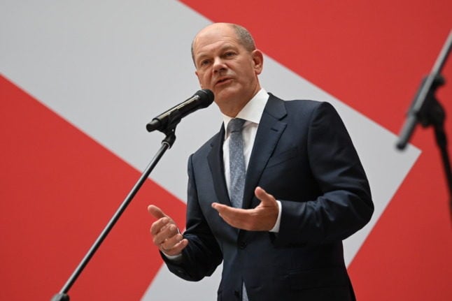 Olaf Scholz addresses reporters during a press conference