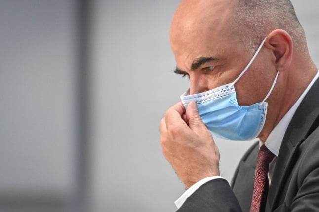 Swiss Interior and Health Minister Alain Berset gestures during a press conference. (Photo by Fabrice COFFRINI / AFP)
