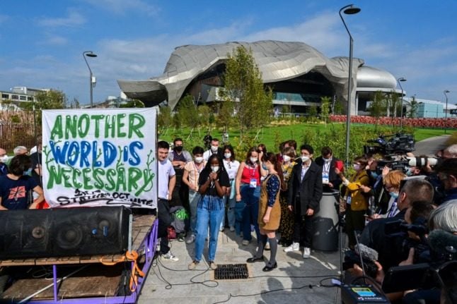 Climate activists outside the Milan Conference Centre, MiCO.