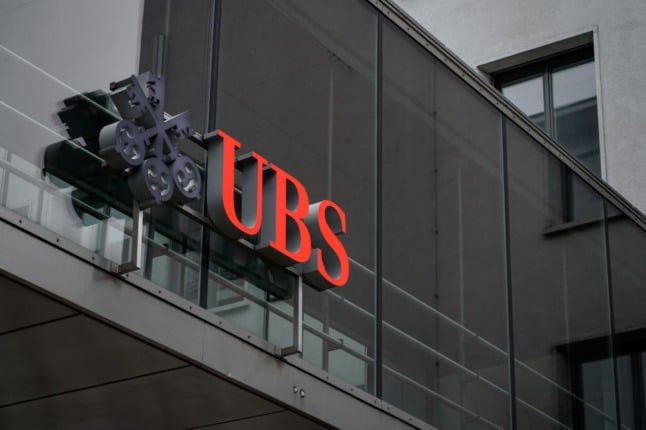A large UBS logo placed on a window of a building