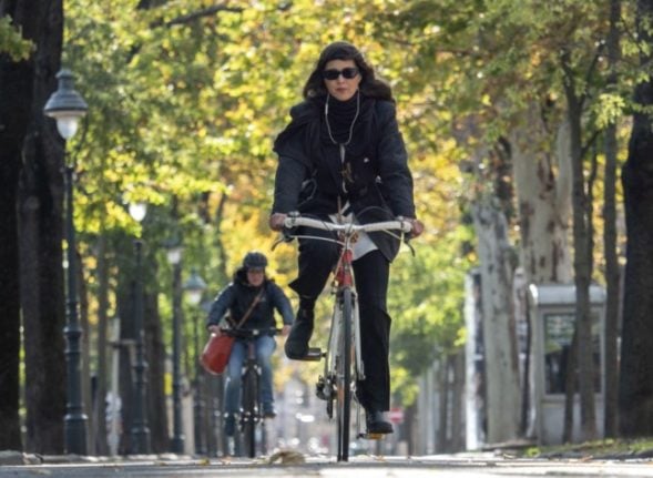 A woman cycling in the park.