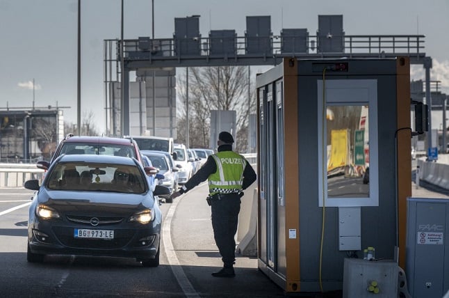 Austrian police officer checks cars at Hungary border