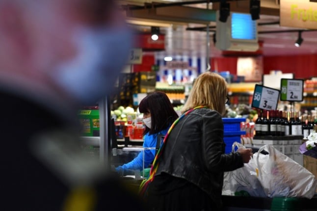 a cashier and a customer at a supermarket in spain