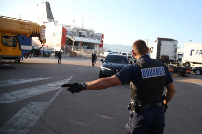 French customs officers checking arrivals at the border.