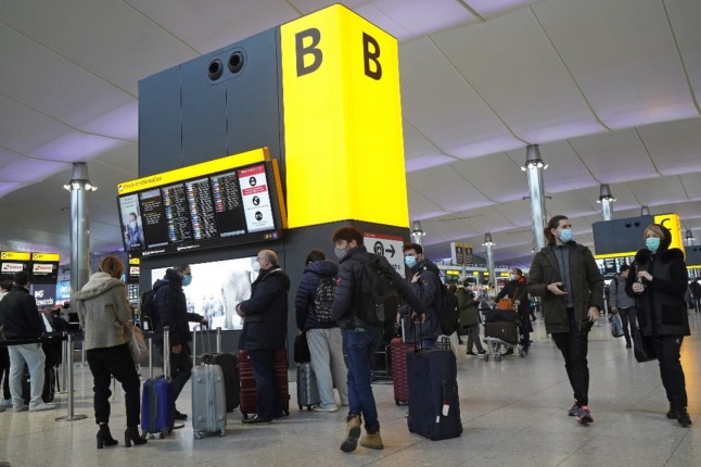 Travellers at a UK airport.