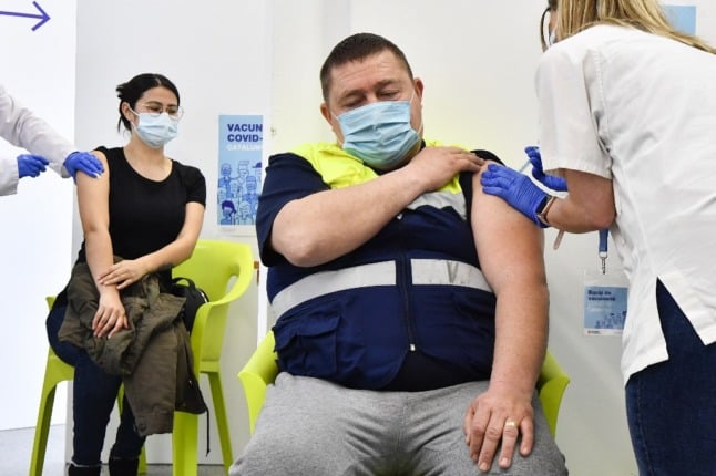 A man received the flu vaccine in Spain. Most regional health authorities will administer a third Covid-19 booster vaccine along with the flu vaccine. 