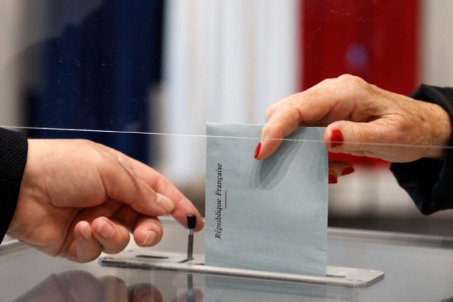 A voter casts her ballot for the second round of French regional elections in June 2021.