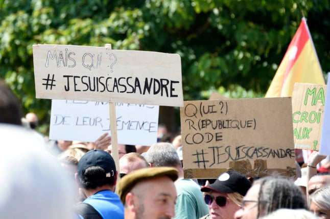 Demonstrators hold up placards that read, '#I am Cassandre' during a demonstration on August 14th, refering to Cassandre Fristot who was arrested for her antisemitic sign during a demonstration.