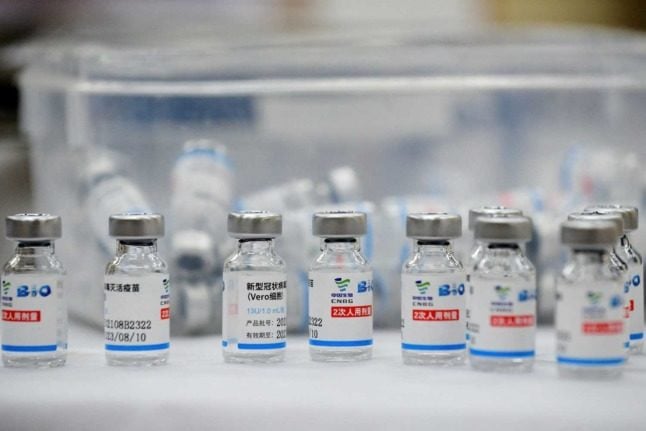 Empty vials of the Sinopharm Covid-19 coronavirus vaccine are kept on a table at a vaccination centre.