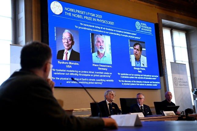 Goran K. Hansson, Secretary General of the Royal Swedish Academy of Sciences (centre)announces the co-winners of the 2021 Nobel Prize in Physics (L-R) Syukuro Manabe (US-Japan), Klaus Hasselmann (Germany) and Giorgio Parisi (Italy) at the Royal Swedish Academy of Sciences in Stockholm. 