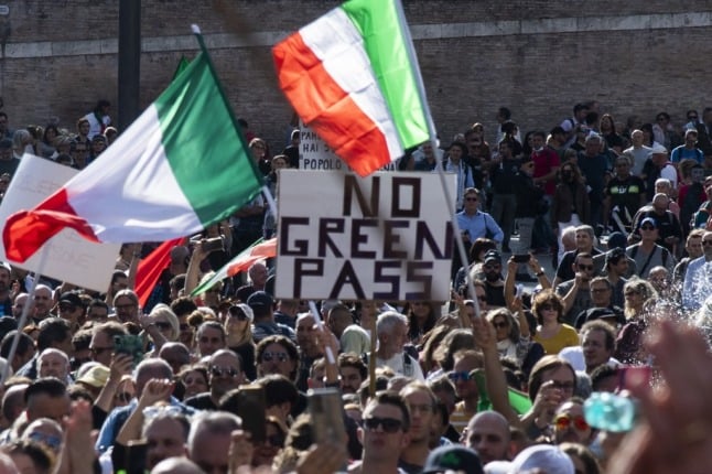People wave national flags during a protest in central Rome 