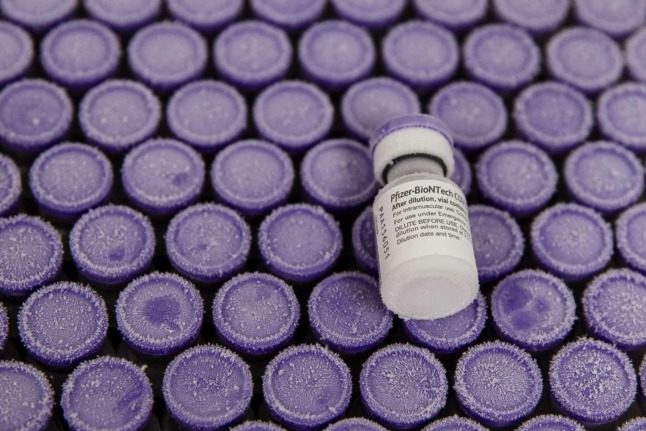 Several vials of Covid vaccine with purple lids