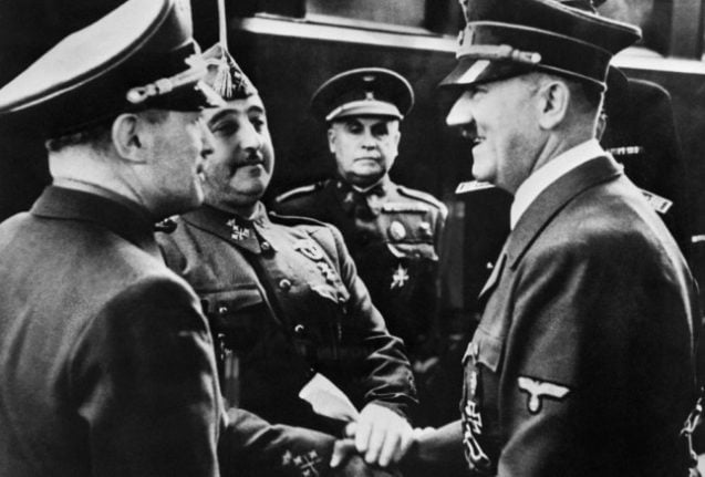 Nazi leader German Chancellor Adolf Hitler (R) shakes hands with Spanish Generalísimo Francisco Franco at Hendaye train station on the French-Spanish border in October 1940. (Photo by AFP)