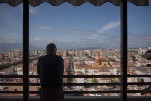 man on balcony in the city of malaga in southern spain
