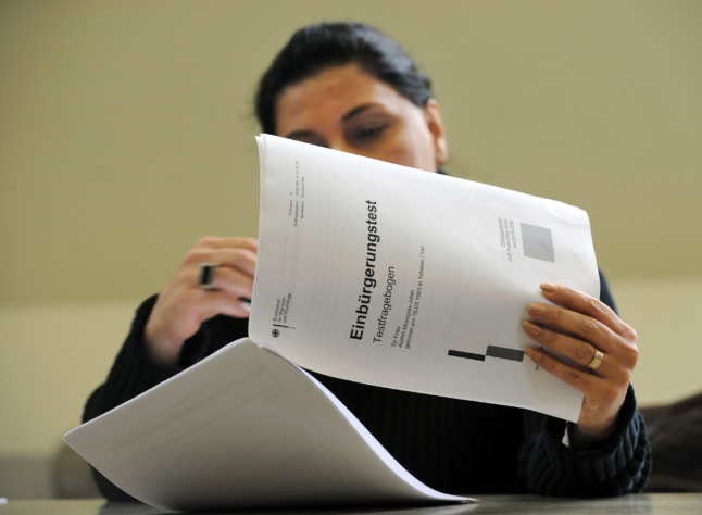 A woman fills in the German citizenship test