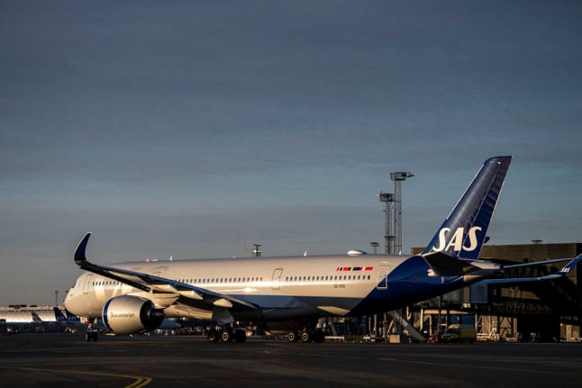 A SAS aircraft on the tarmac at Copenhagen Airport. Denmark is to lift most of its Covid-19 travel restrictions by the end of this month and simplify the remainder.