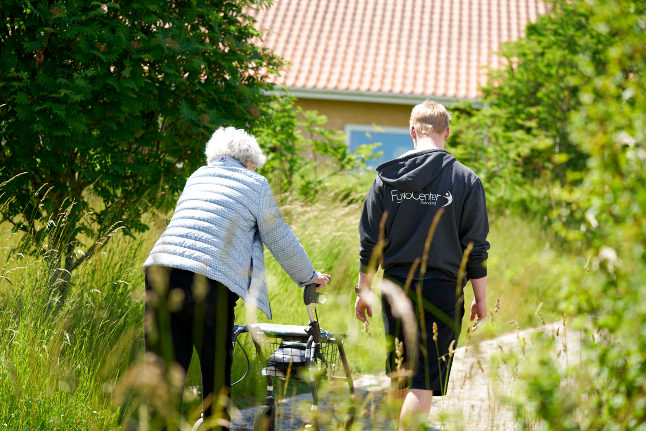An old woman takes a walk at an elderly care home in Denmark. There has been a slight increase in the number of vaccinated old people being hospitalised with Covid-19
