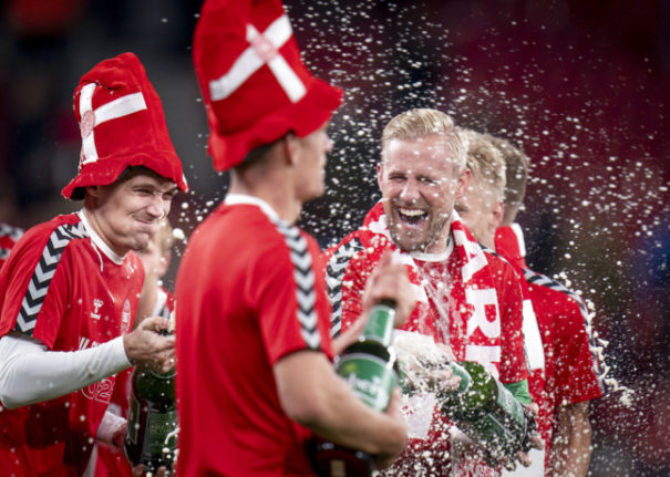 Denmark's players celebrate World Cup qualification after defeating Austria in Copenhagen.