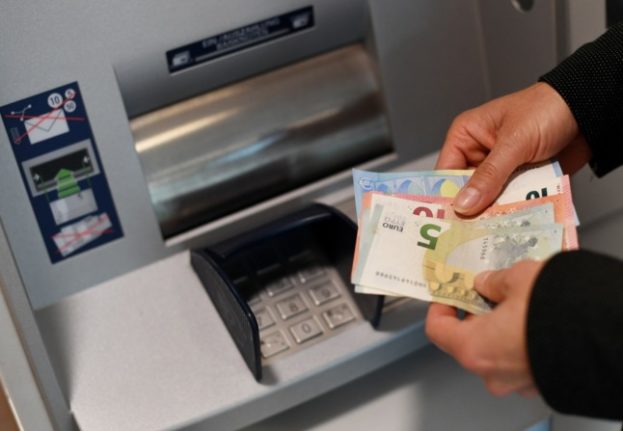 A woman takes money out of a cash machine in Garmisch-Partenkirchen. 