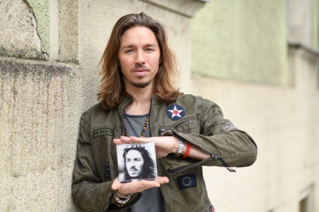 Gil Ofarim holds up a copy of his album
