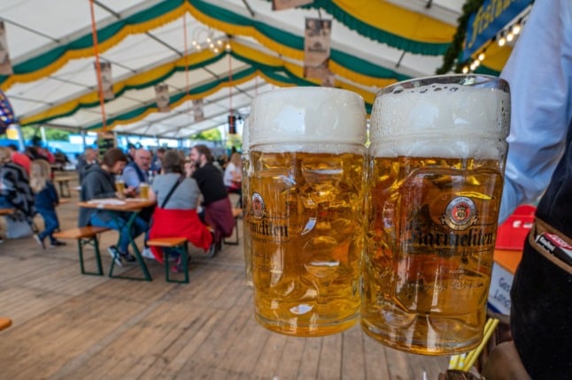 A server with two big beers at a festival in Straubing, Bavaria, in August. 