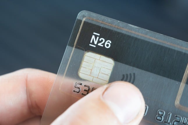 A person holds a N26 bank card. 