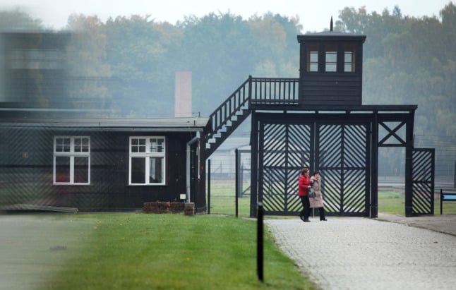Visitors walk past the entrance to the Stutthof Museum in Sztutowo, Poland.