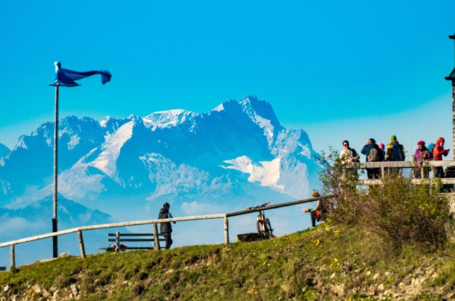 People climb the Wahlberg in front of the Zugspitze in Bavaria.