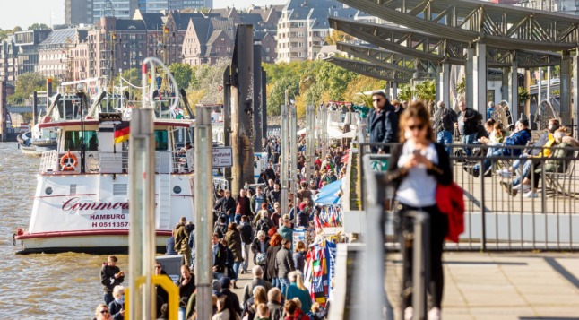 People walk in Hamburg near the Elbe river earlier in October. 