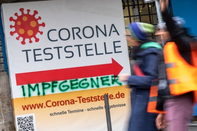 A Covid-19 test centre in Munich with the word 'vaccine opponents' sprayed on in graffiti.
