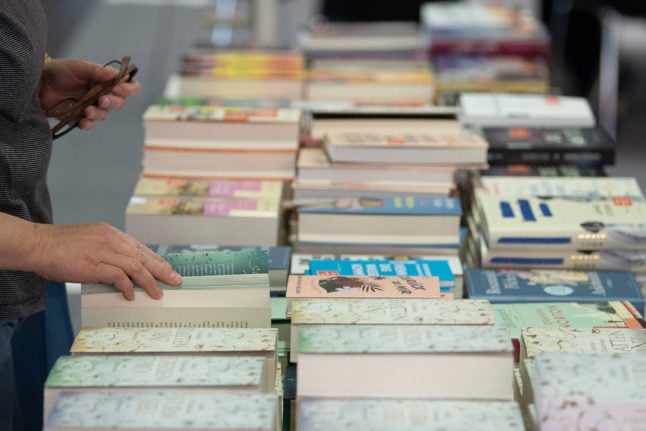 A woman browses books at Frankfurt Book Fair